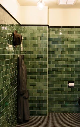 hunter green subway tile on wall in bathroom