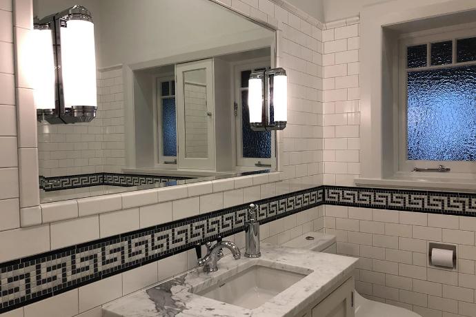 white subway tile on wall in bathroom