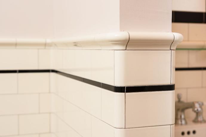 close up picture of white subway tile with black grout